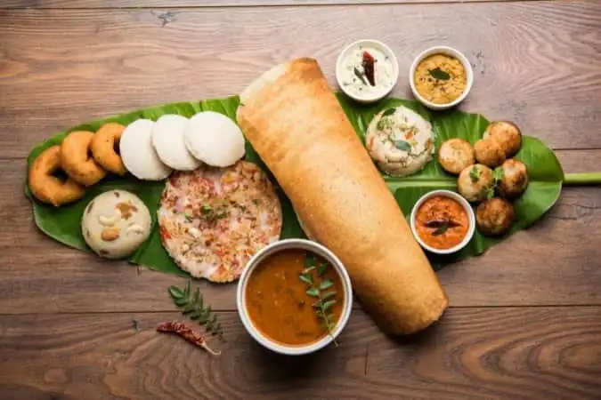 A full South Indian breakfast platter on a banana leaf